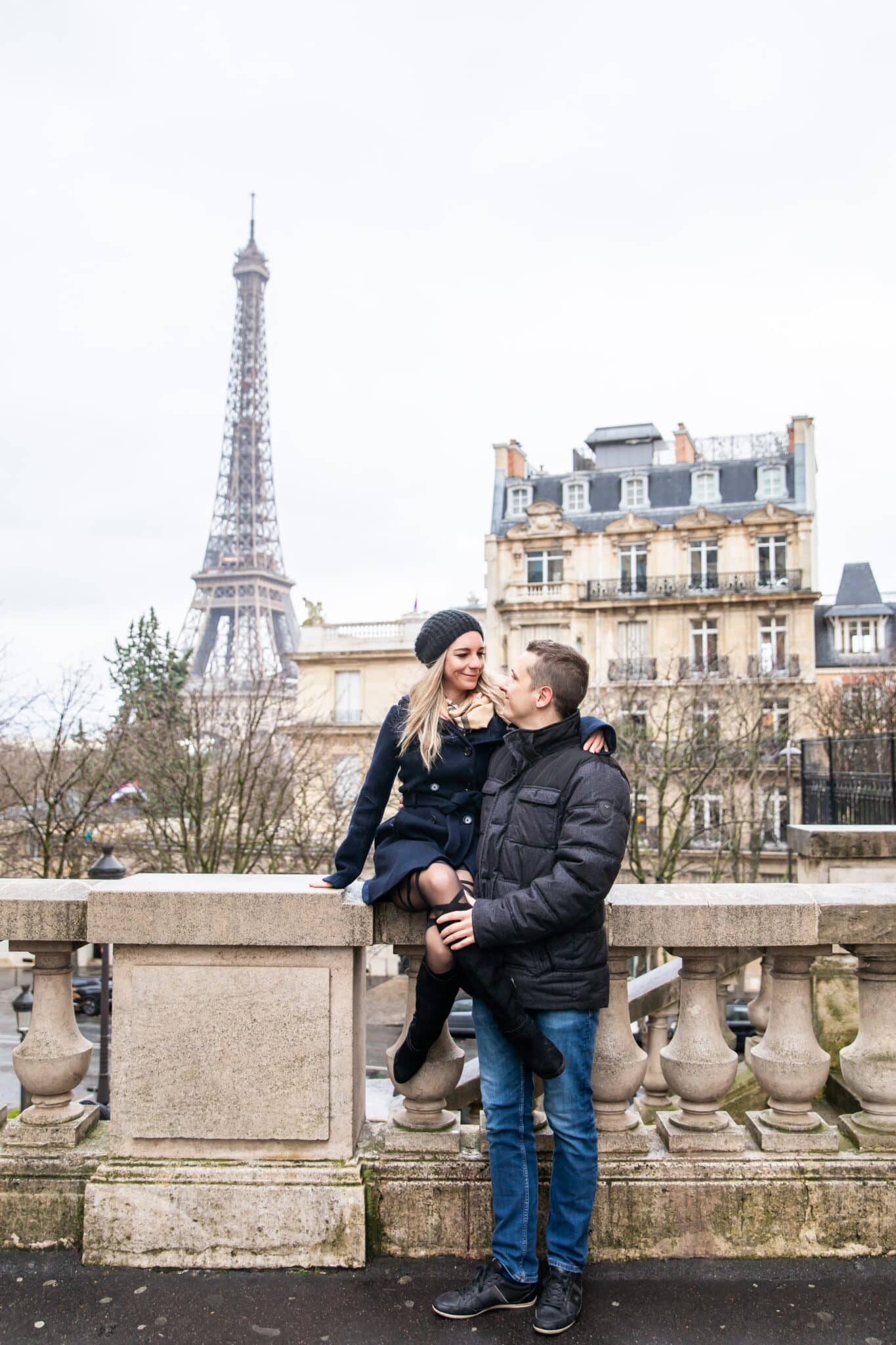 picture of the author and her husband in christmas clothes in paris in front of the eiffel tower