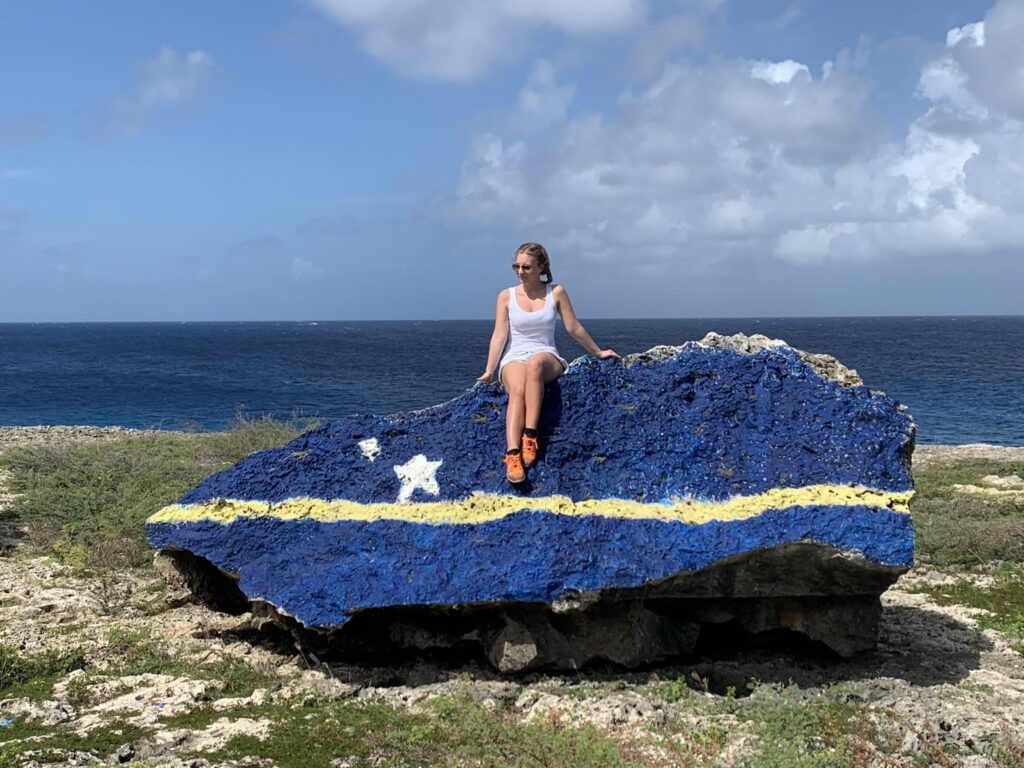 Curacao Rock next to Watamula Hole, with blonde girl on top, instagrammable spot Curacao