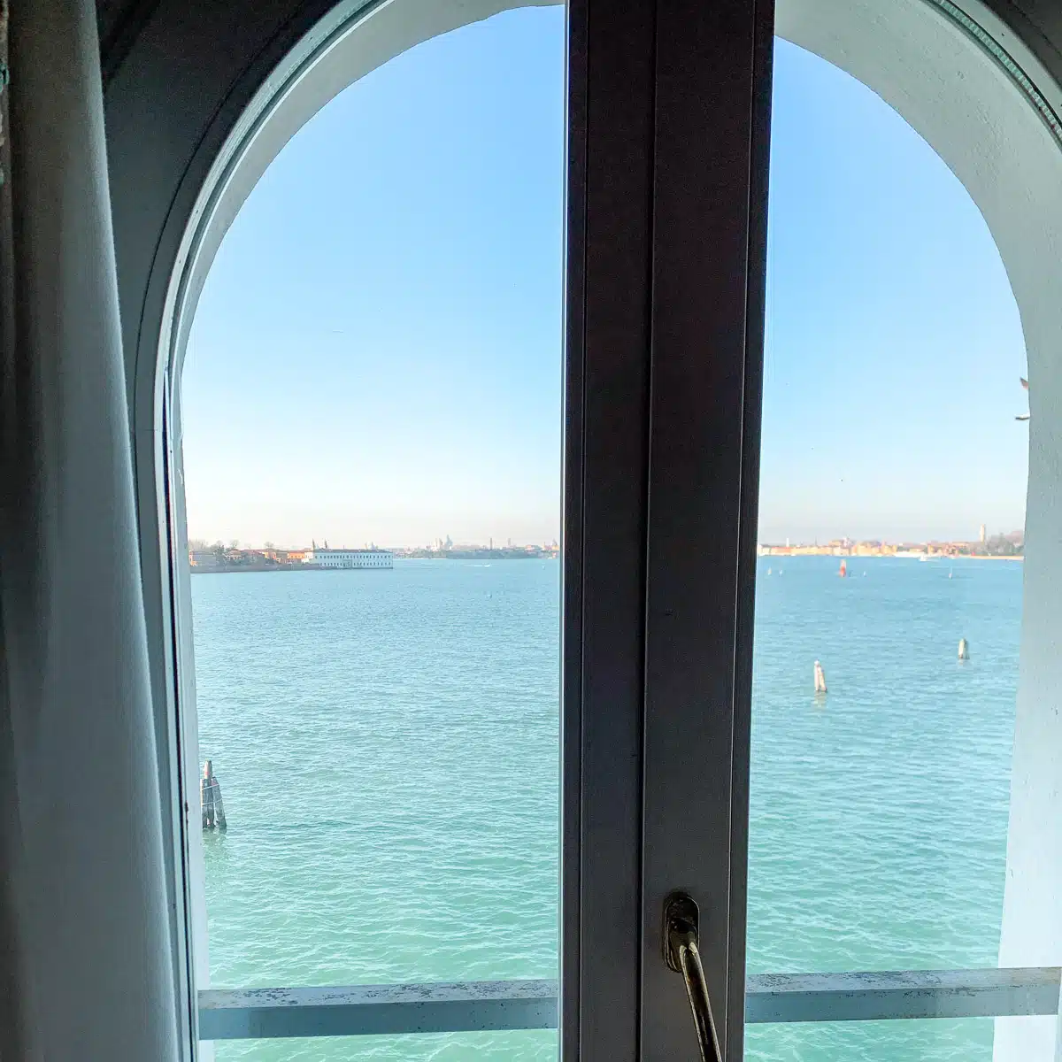 Venice hotel room view from the window of the lagoon with stunning clear blue water