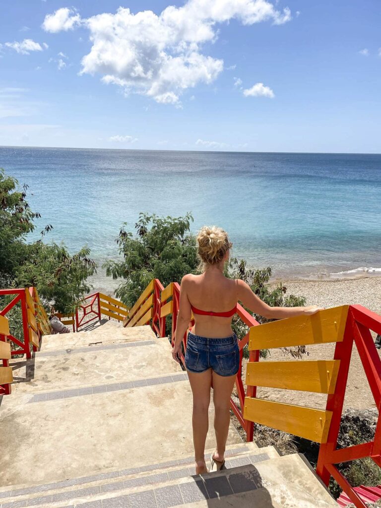Playa forti shot of girl with ocean and colorful staircase in the background