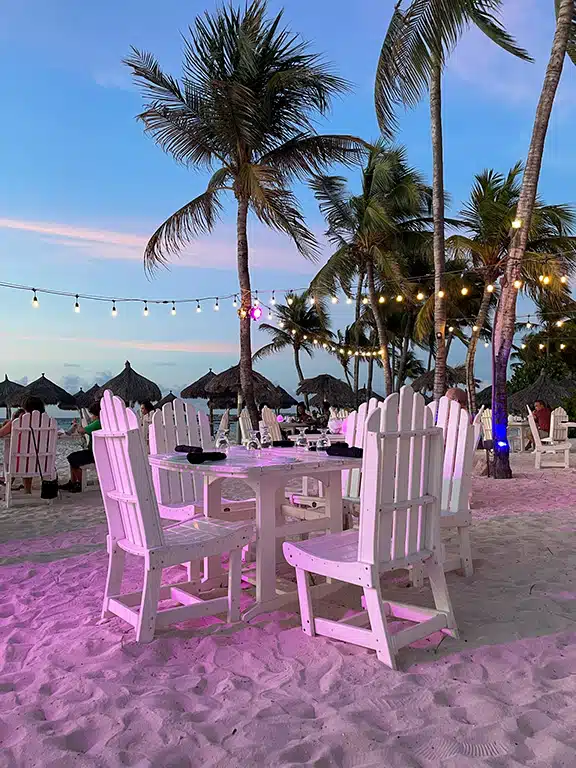Romantic table setting on the beach with soft ambient lighting