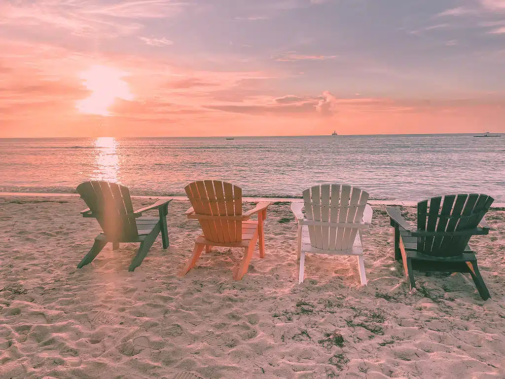 Photogenic chairs on the beach by a beautiful sunset at Divi Phoenix Resort beach