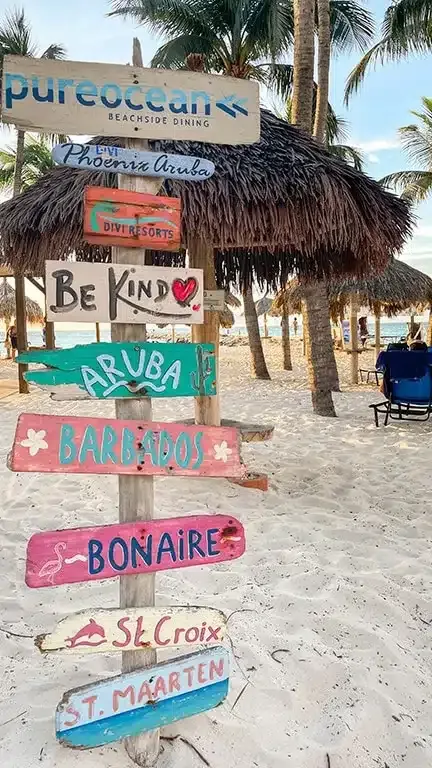 Beach in Divi Phoenix resort with driftwood signs in colors