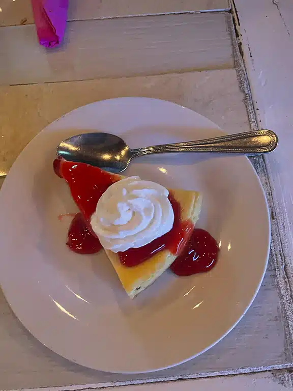 Cheesecake on a plate with strawberry sauce