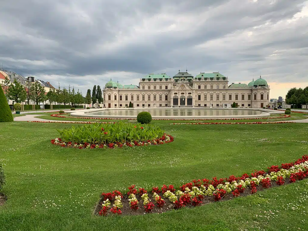 Belvedere castle baroque building in front big flower beds and pond