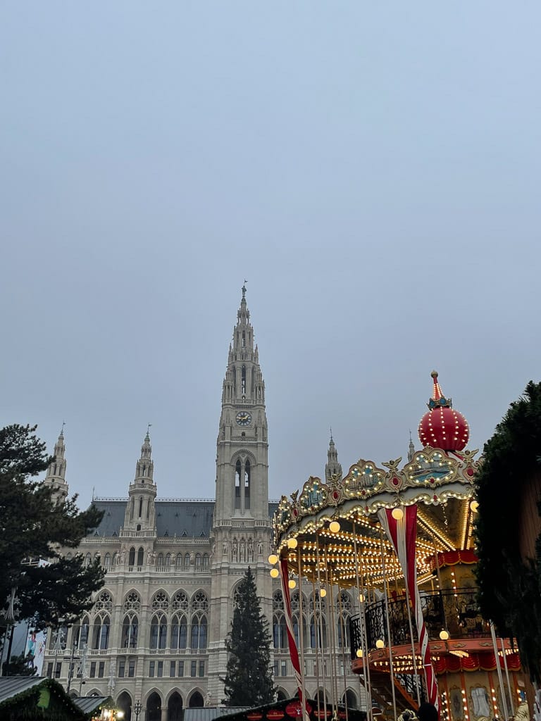 Vienna, Austria Rathaus with carousel in front of it and big christmas tree in the back