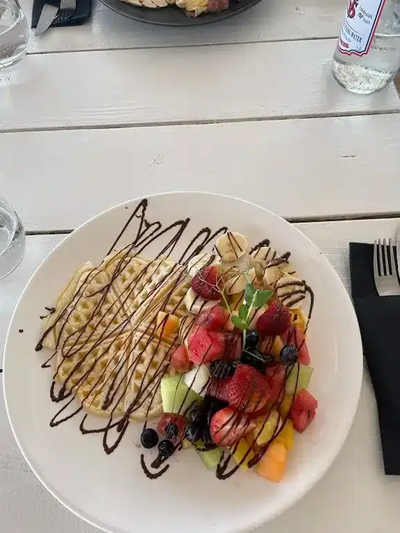 Waffles and colourful fruit at BijBlauw restaurant