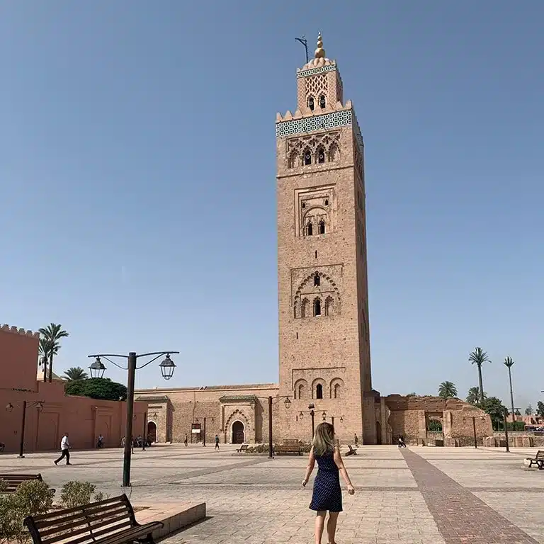 The author posing in front of a mosque in Marrakech