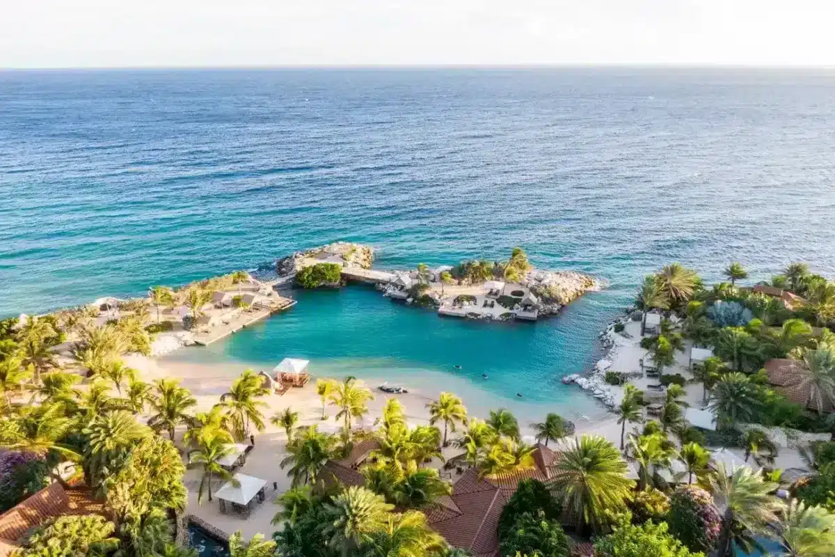 Drone view of amazing white sandy beach at Baoase Resort and stunning blue water