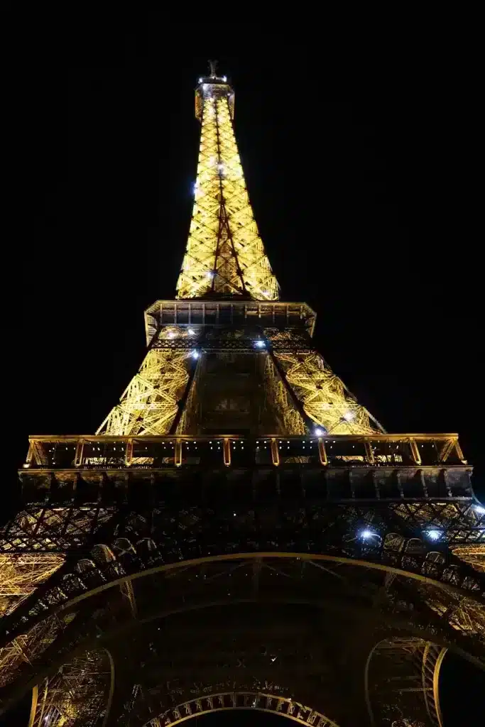 Eiffel tower at night in Paris sparkling lights