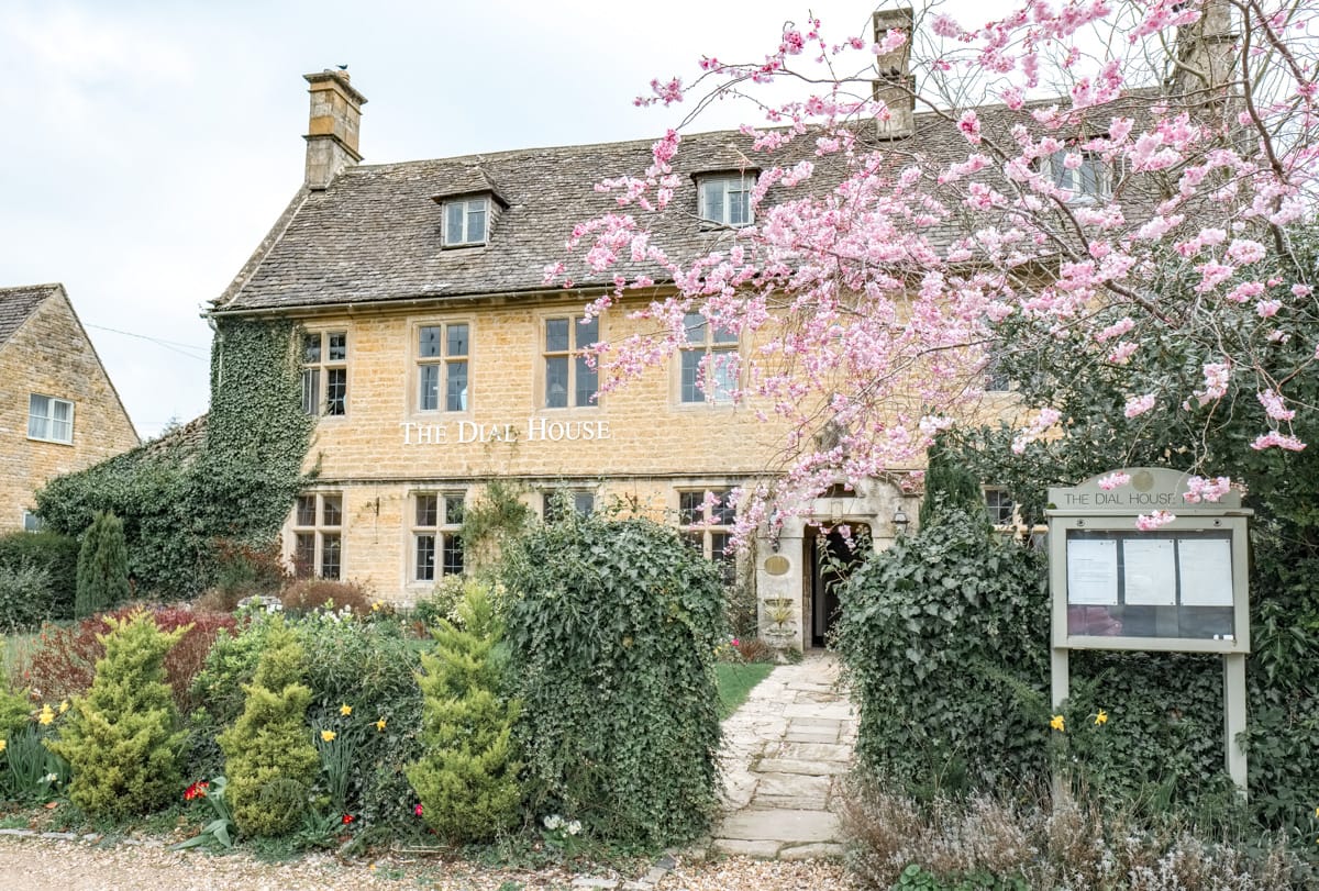 beautiful cottage house in the cotswolds in spring with cherry blossoms around