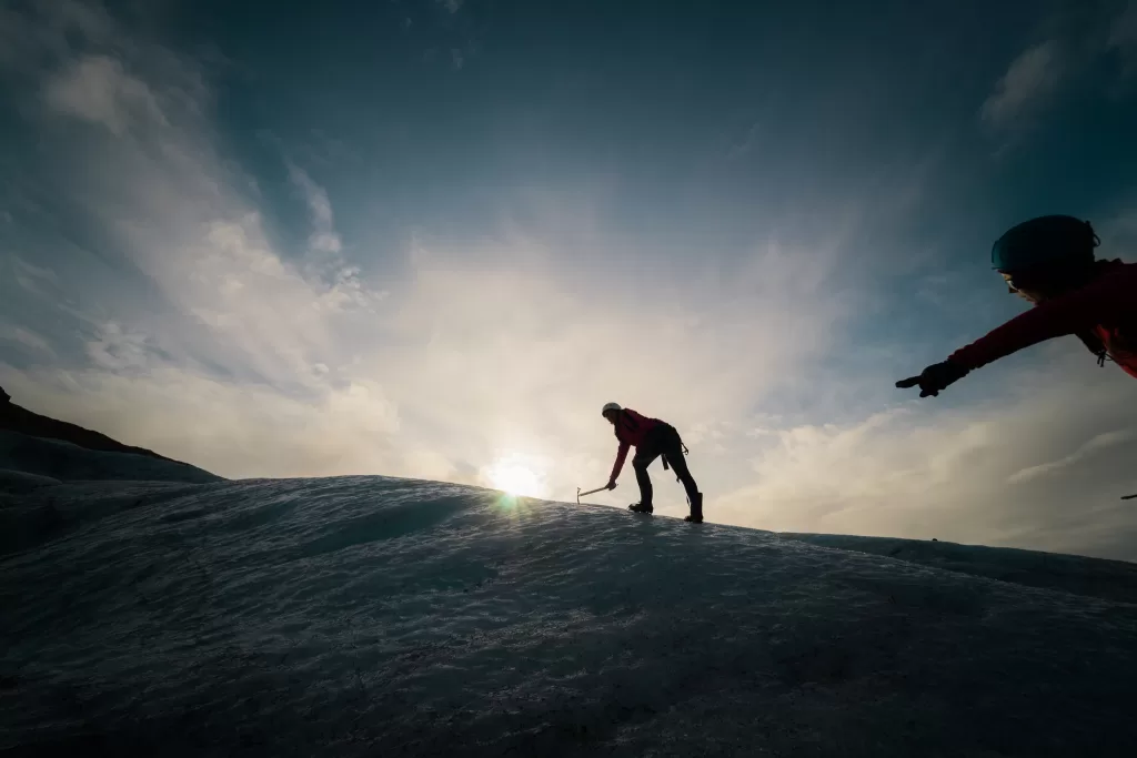 two people hiking in iceland on the glacier at sunrise adventure bucket list
