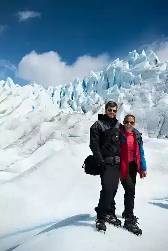 couple standing in front of ice in Patagonia adventure bucket list