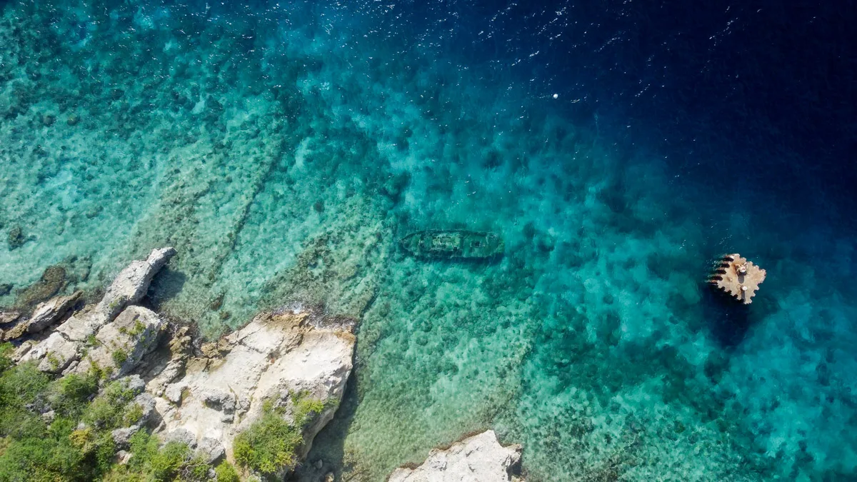 sunken shipwreck drone view at tugboat beach one of the cooles things to do in curacao for snorkel enthusiasts