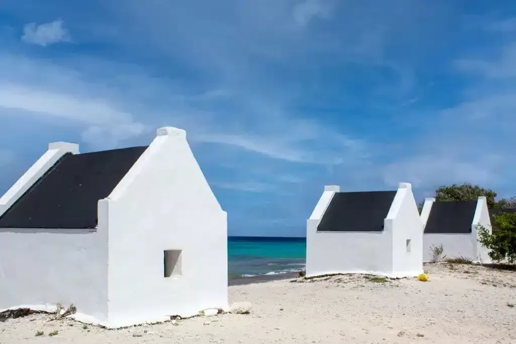 White Slave houses with blue ocean in the background