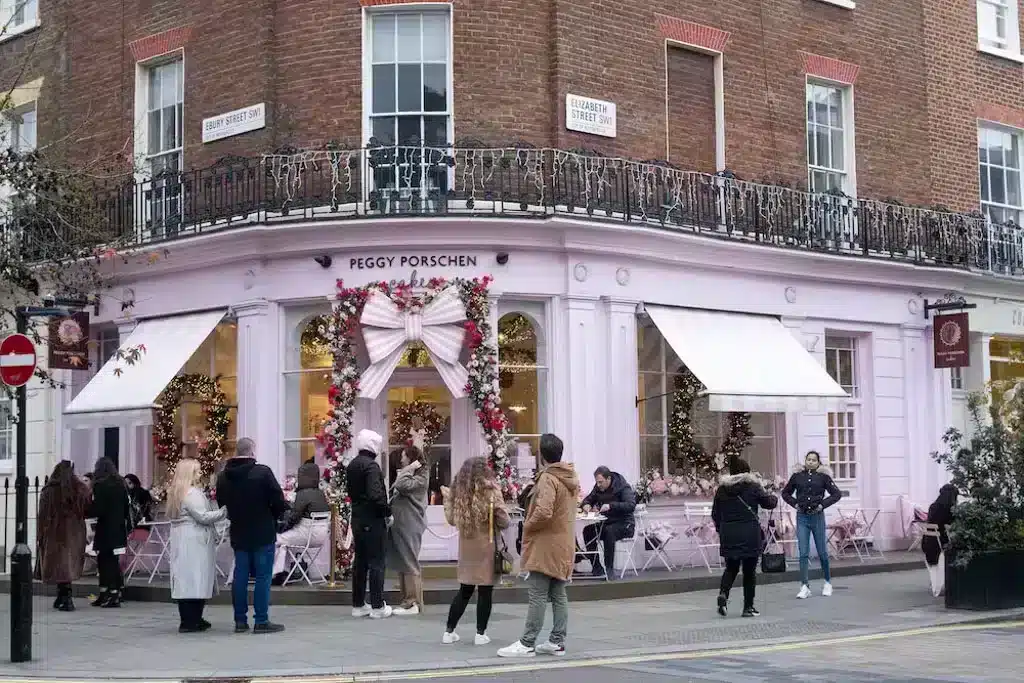 Picture of a pink cafe in London with lots of people taking pictures in front of it for Instagram 