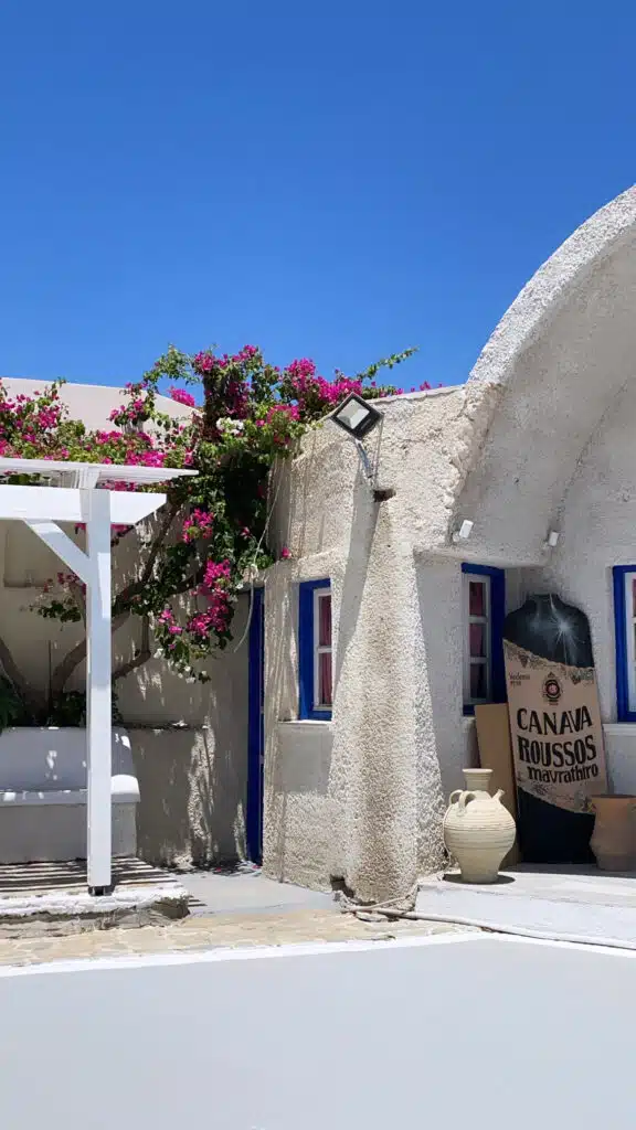 Winery Canava Roussos in santorini entrance of a building with pink flowers