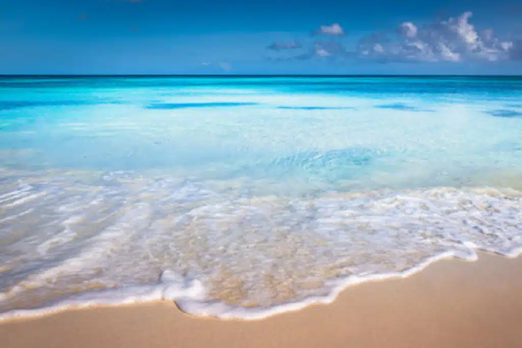 pristine blue ocean on white sandy beach 