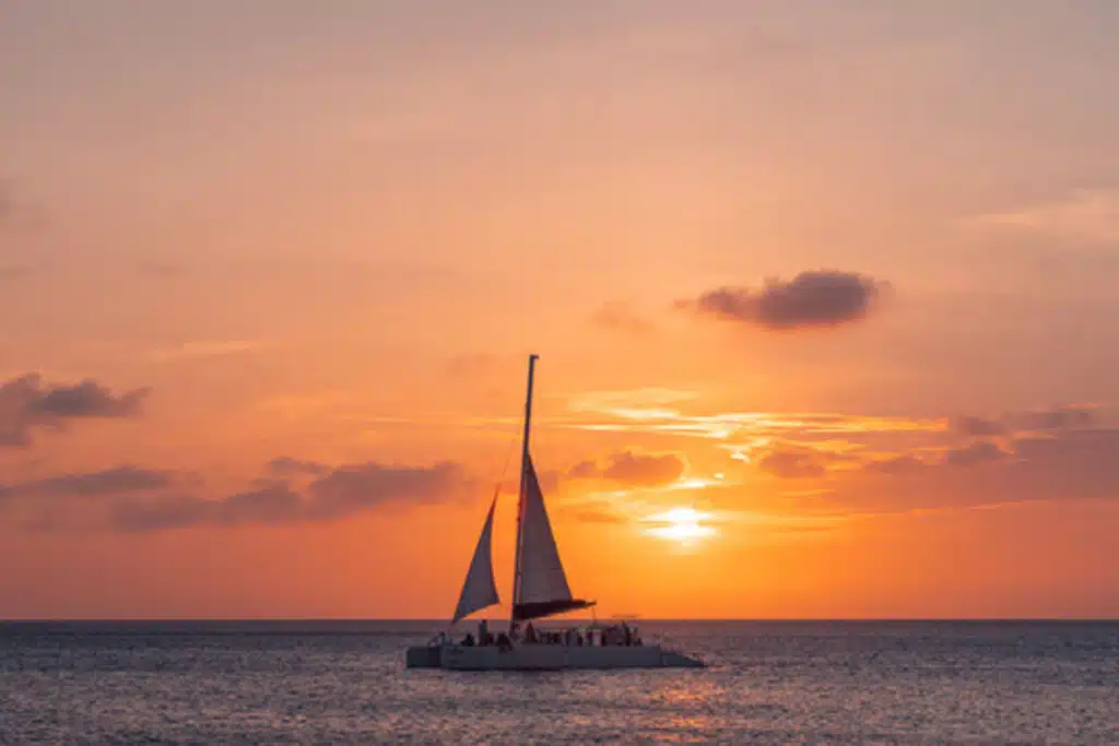 Single Catamaran in front of amazing orange sunset in Aruba