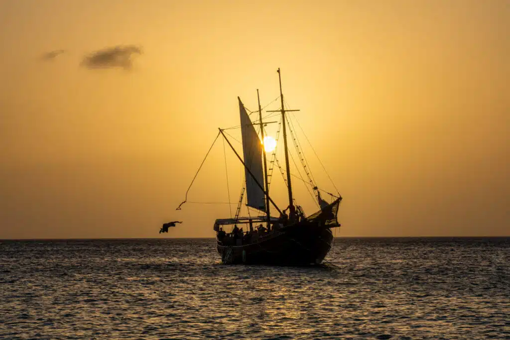 Pirate ship in Aruba with someone jumping from the rope at sunset