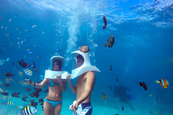 two people underwater snorkeling with helmet on aquafari 