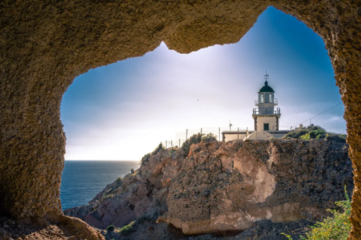 Akrotiri Lighthouse overlooking the ocean picture taken from a cave