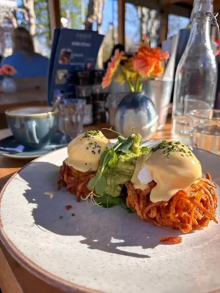 eggs benedict with avocado on tater tots
