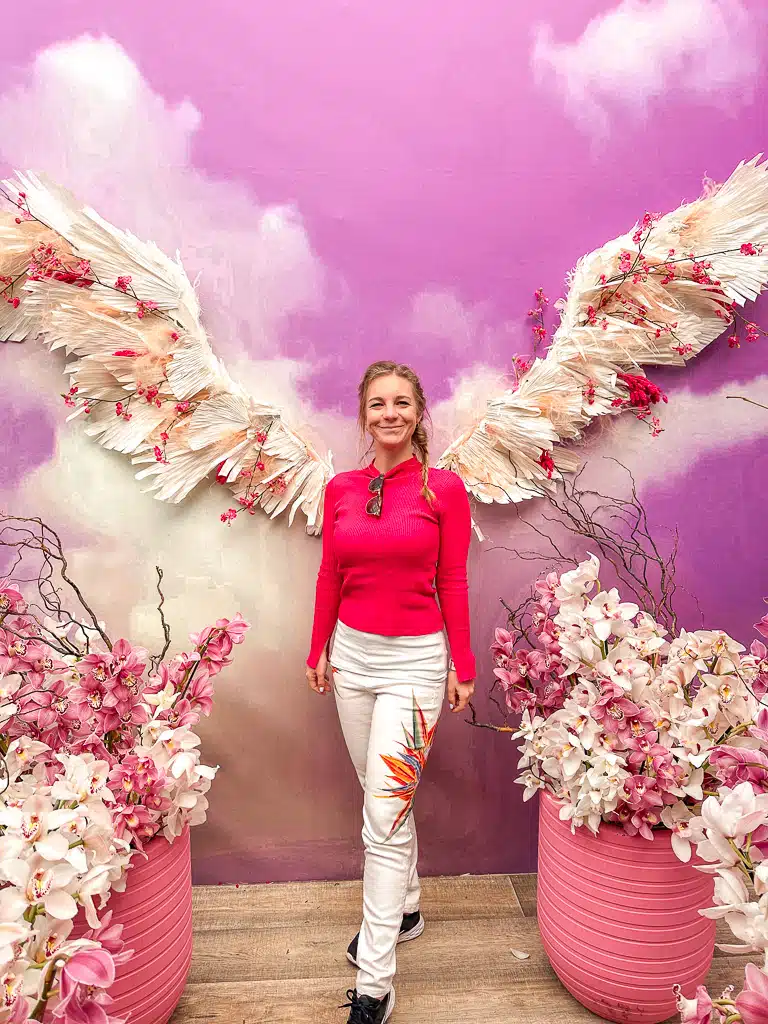 the author with white angel wings made from flowers 