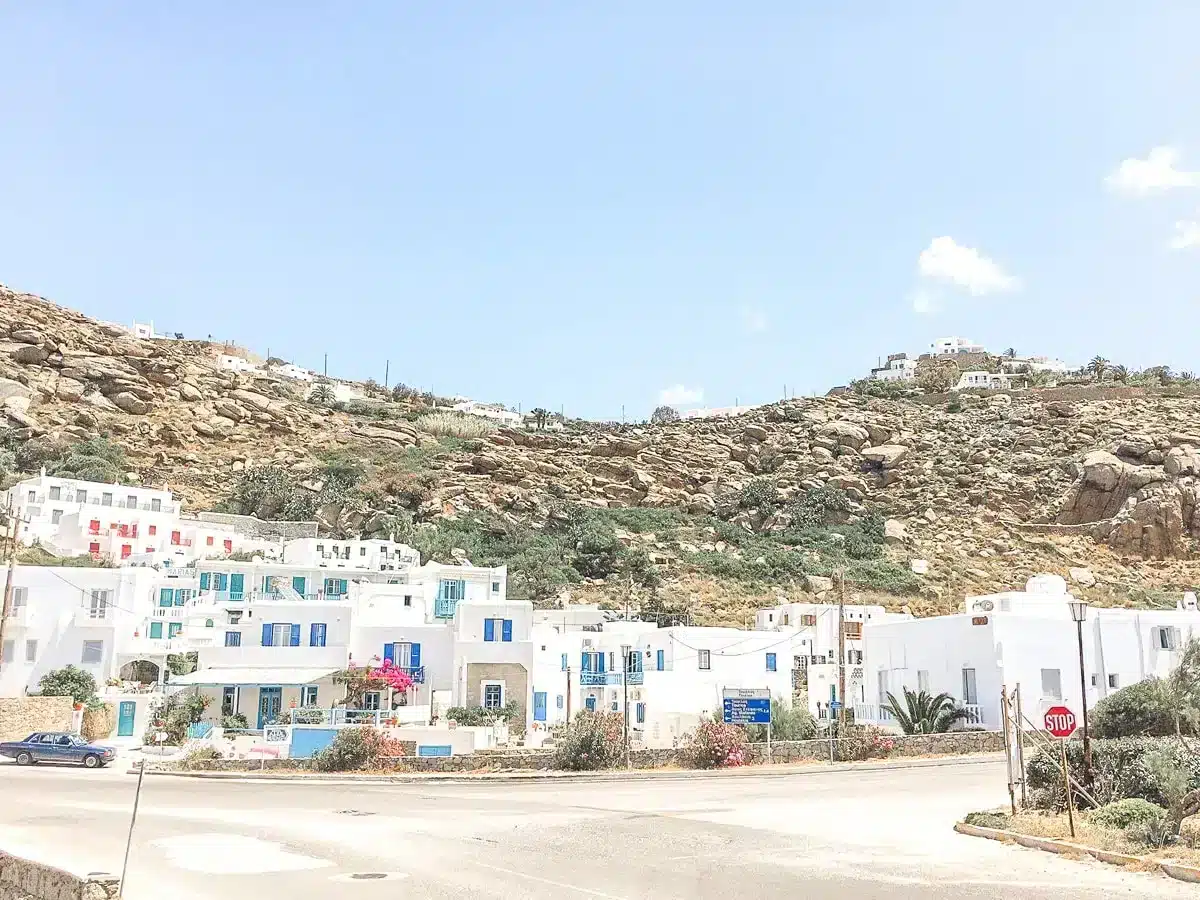 white houses of mykonos cutely next to each other photo taken from the street