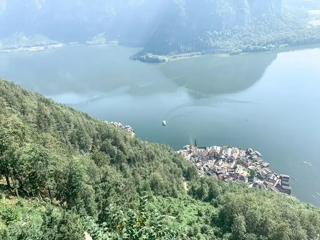 view from the Welterbeblick over the old town of hallstatt and the lake in the background