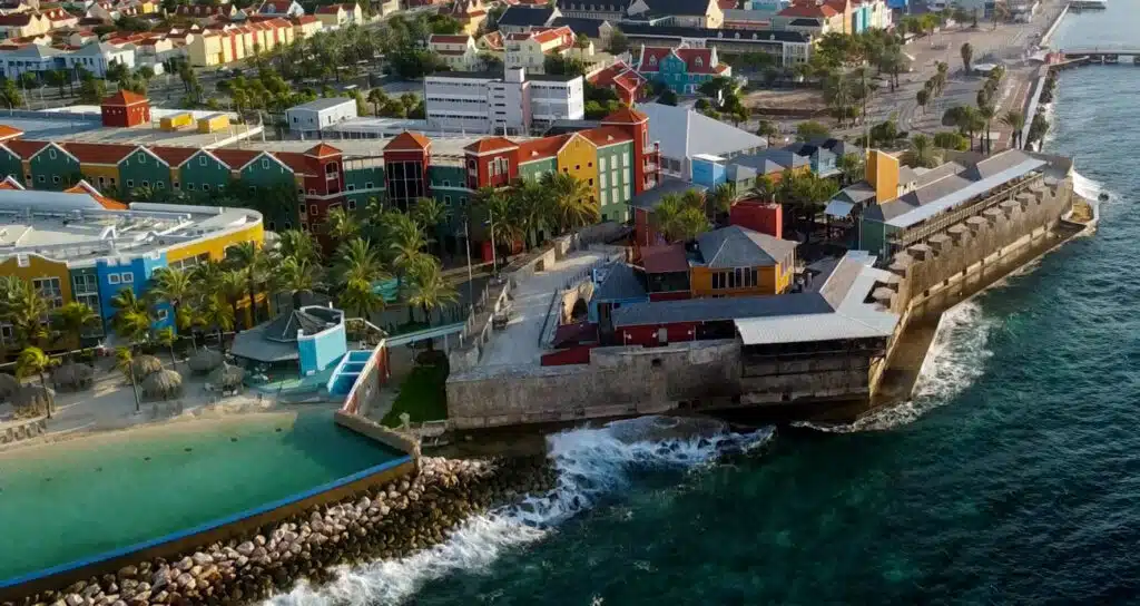 Drone shot of Rif Fort Shopping Center in Curacao with Renaissance Hotel and infinity beach in the middle of Willemstad