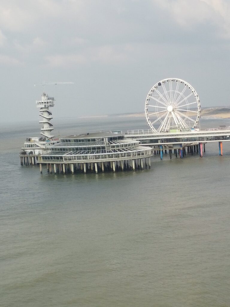 One of the best things to do in Scheveningen, walk on the beach and see the beautiful ferris wheel and the pier drone shot