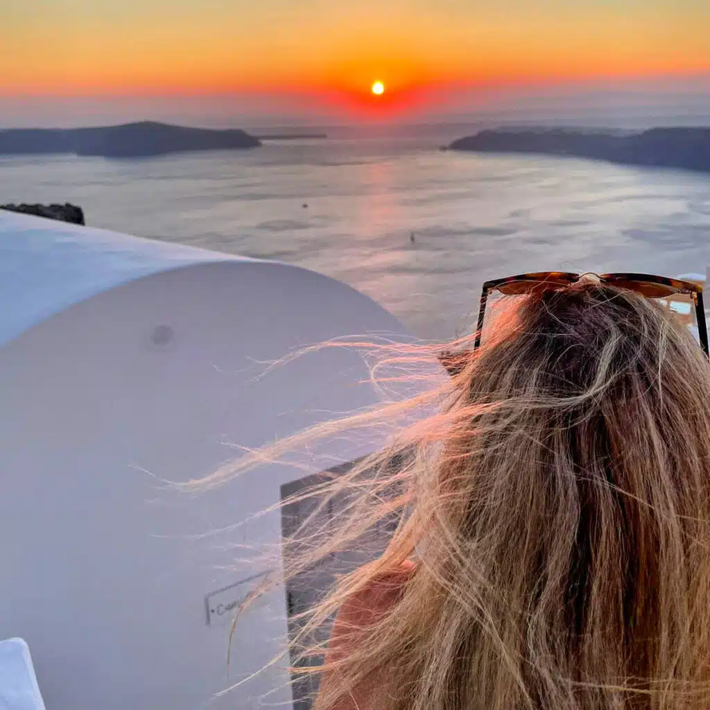 the author from behind watching the sunset in oia 
