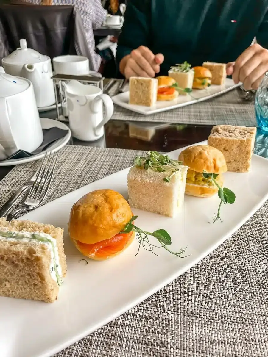 a selection of small sandwhiches at a traditional high tea arrangement