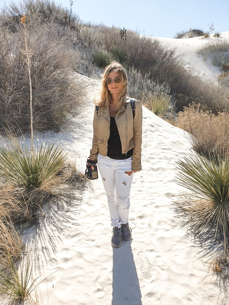 the author's wife with a camera on a hiking trail in the white sands