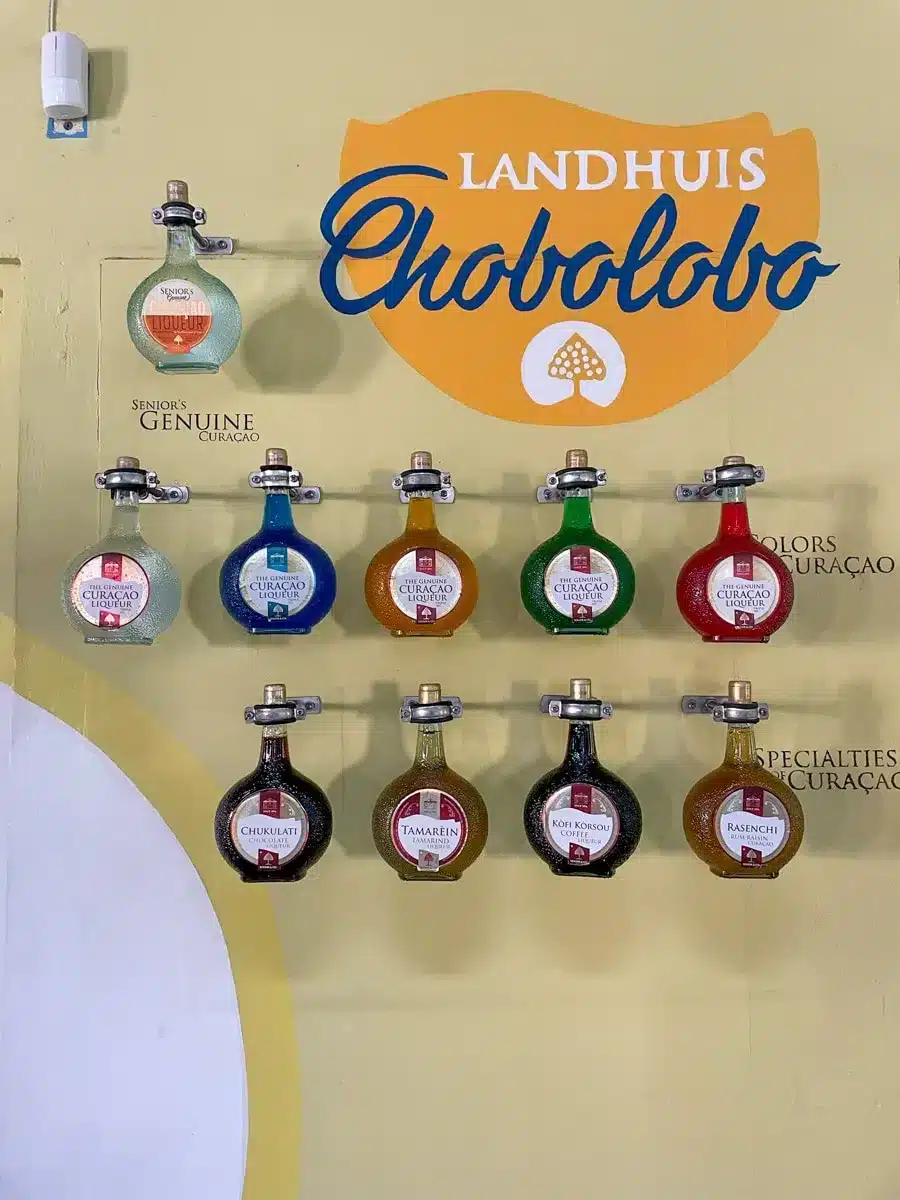 original bottles of the blue curacao liquor hanging at the wall at the landhuis chobolobo, one of the best things to do in curacao