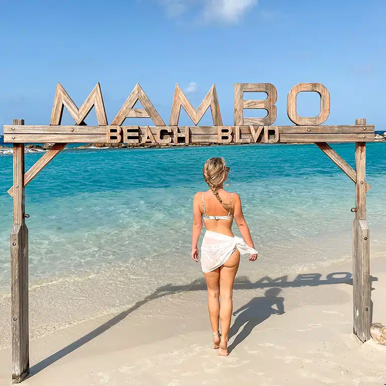 the author at mambo beach sign in curacao