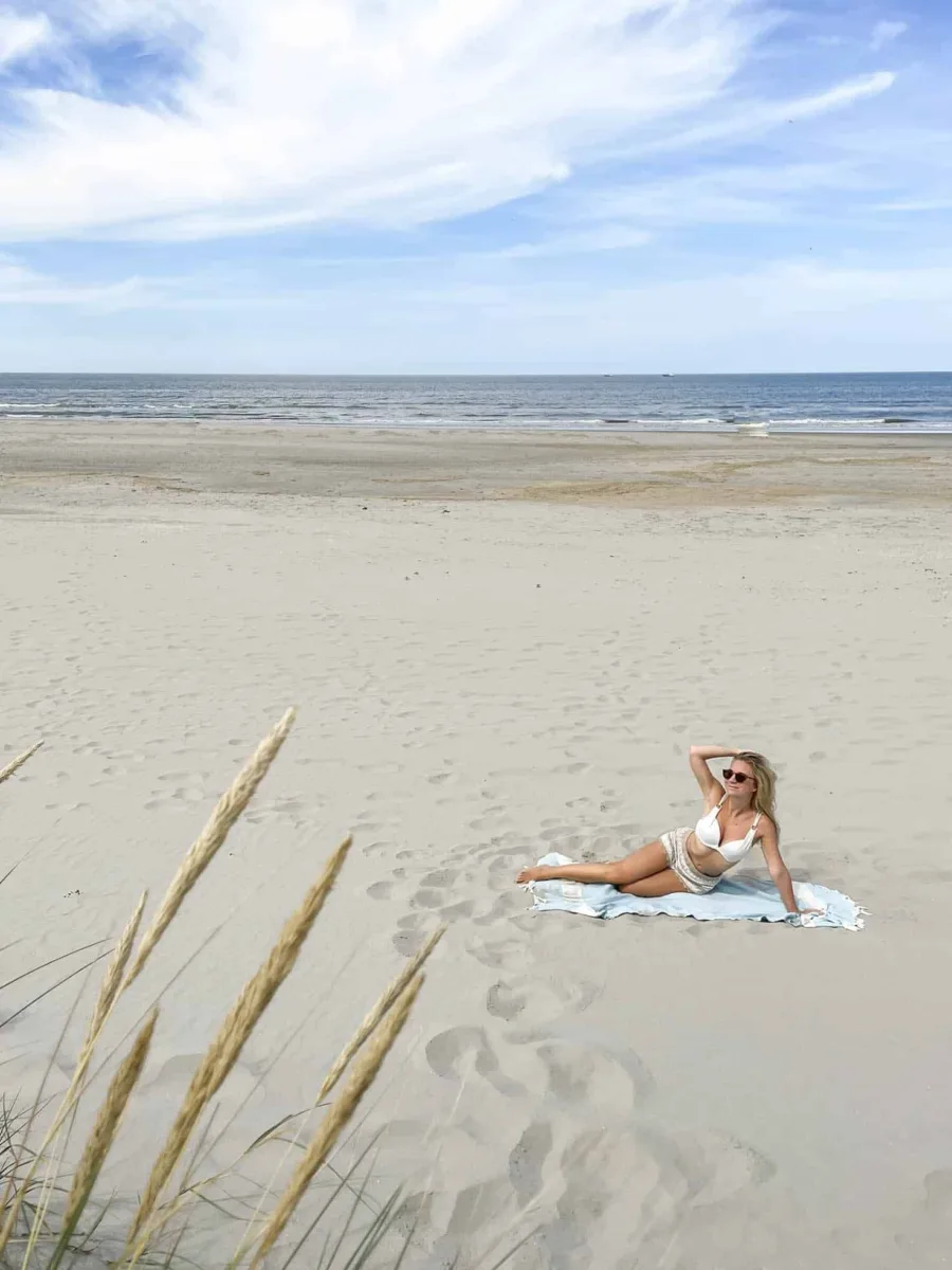 beautiful beach in Ameland with a picture of the Author lying on the beach 