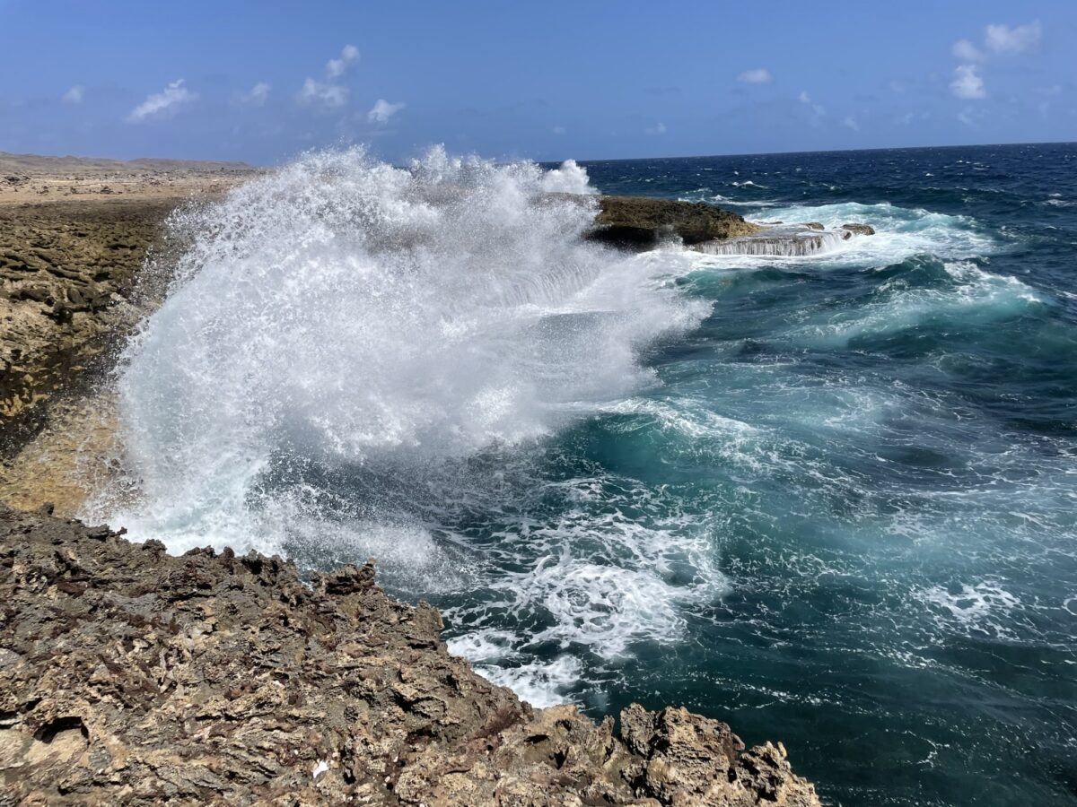 Picture of the beautiful ocean in curacao with 10 high waves crashing onto the cliffs of the shete boka national park
