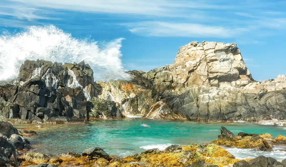 natural pool called conchi in aruba with big waves 