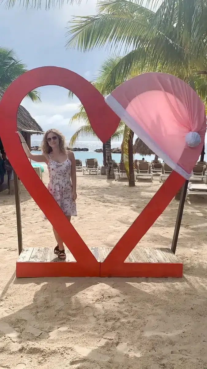 the author standing under a christmas decoration heart in Curacao