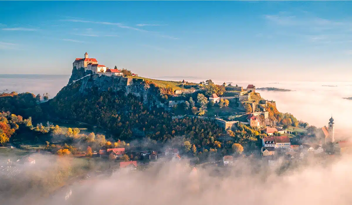 beautiful riegersburg castle on a big hill with fog in the foreground