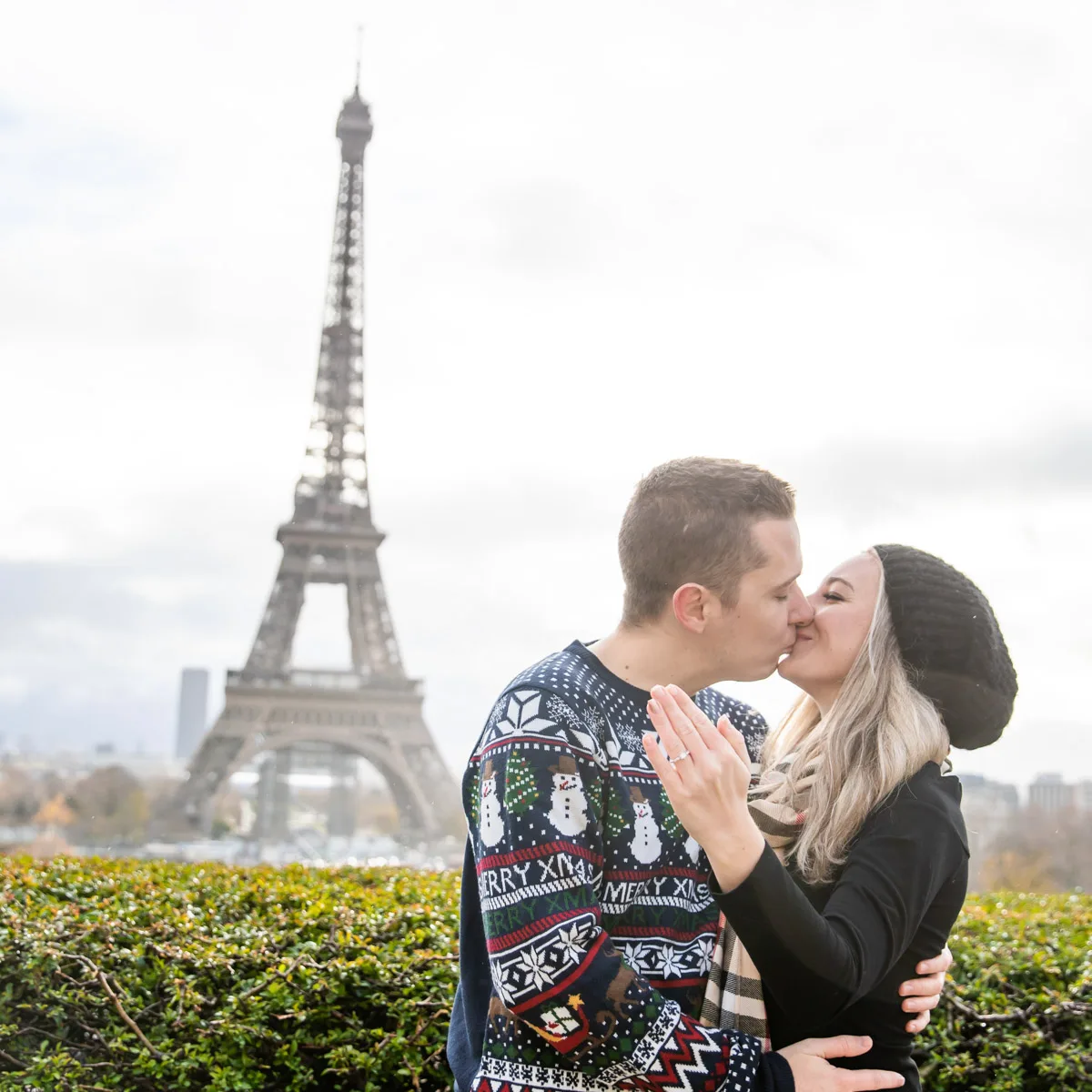 picture of the author and her husband in christmas clothes in paris in front of the eiffel tower