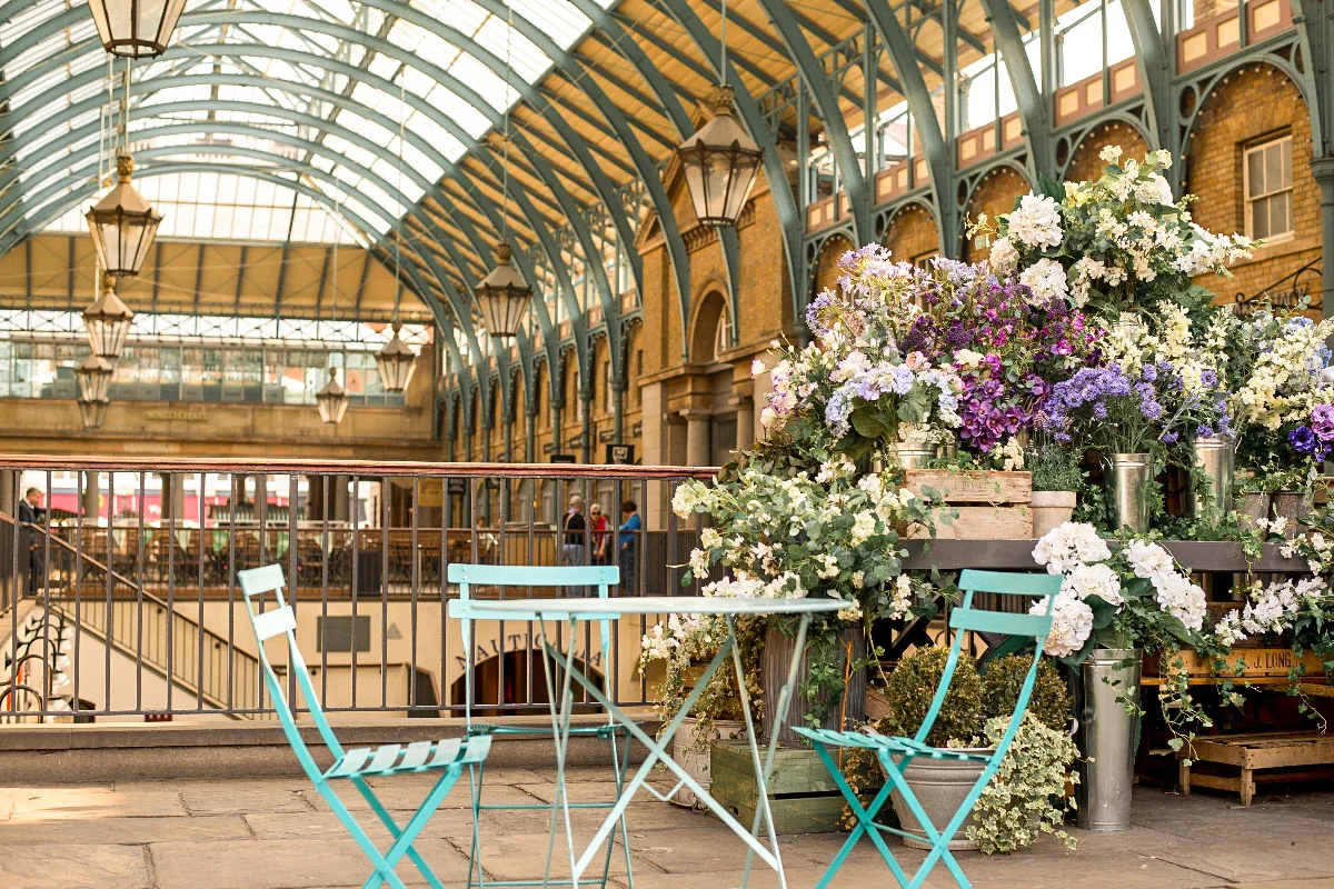 beautiful covent garden with a cafe with table and chairs and flower bouquets