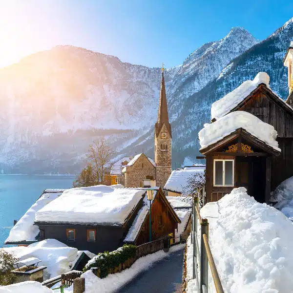 picture of a beautiful house in hallstatt with a view from a hotel room over the lake and the snow