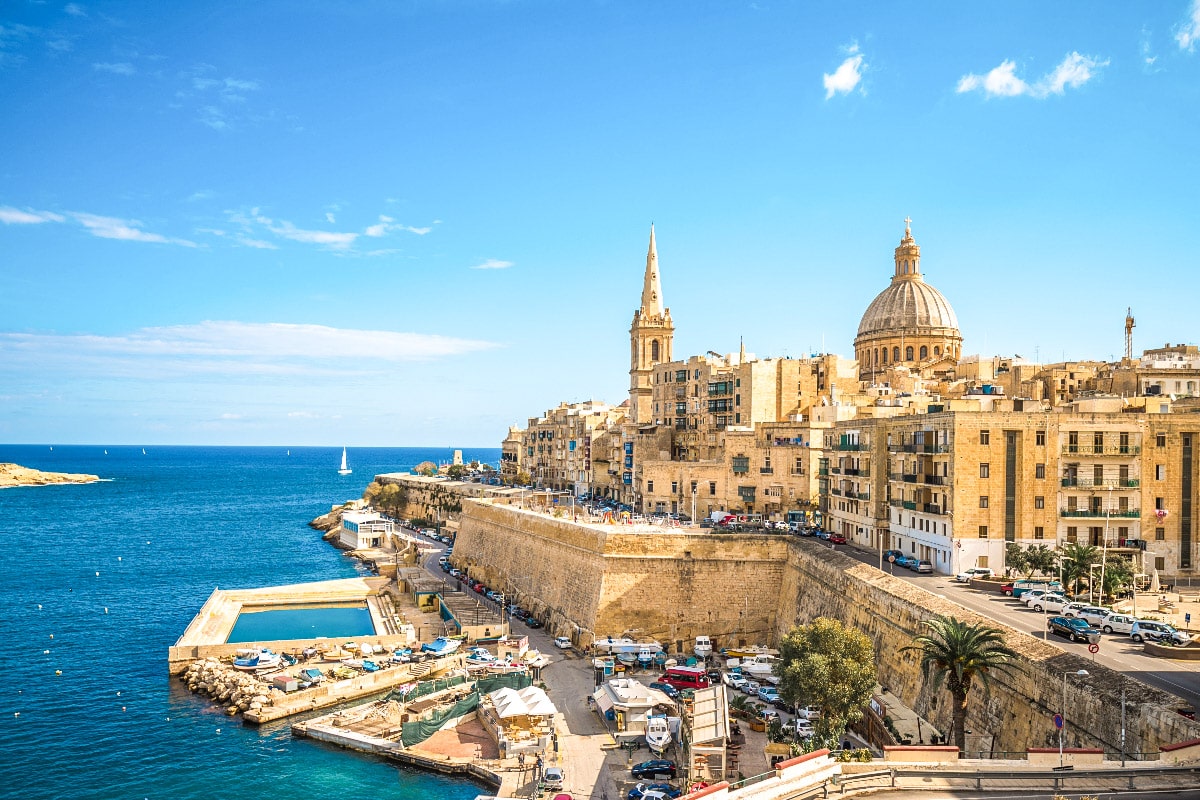 picture of the capital city valletta with the ocean and the port in the background