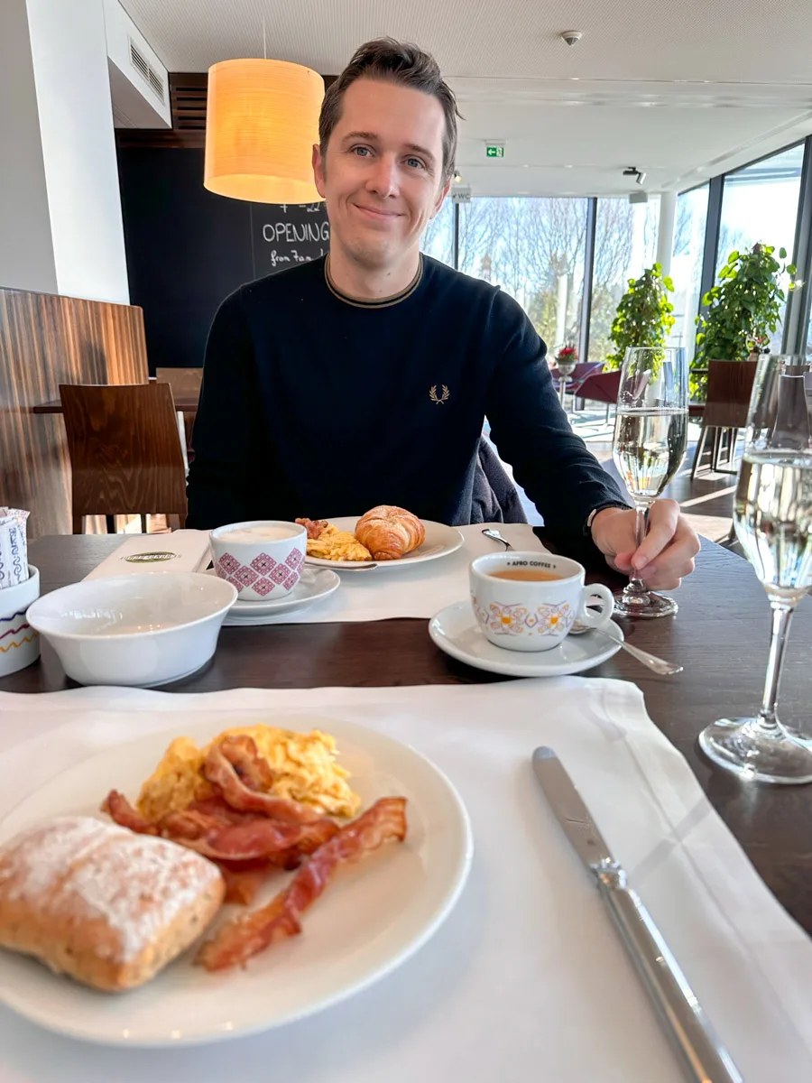 picture of the authors husband while having breakfast with champagne at the schoenberghof