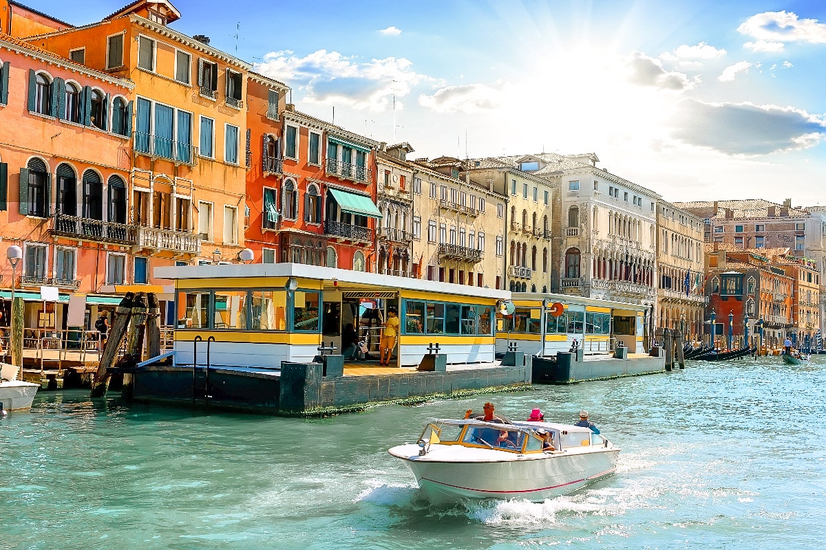 water taxi station in venice on a canal with colorful buildings