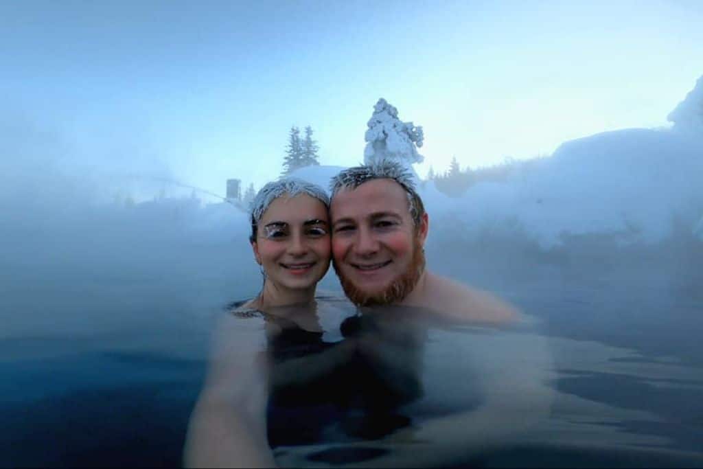 the authors friend and her husband in the chena hot springs in alaska