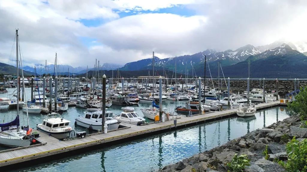 stunning port of seward with cute little boats in line and glacier in the background first stop on alaska 7 days itinerary.
